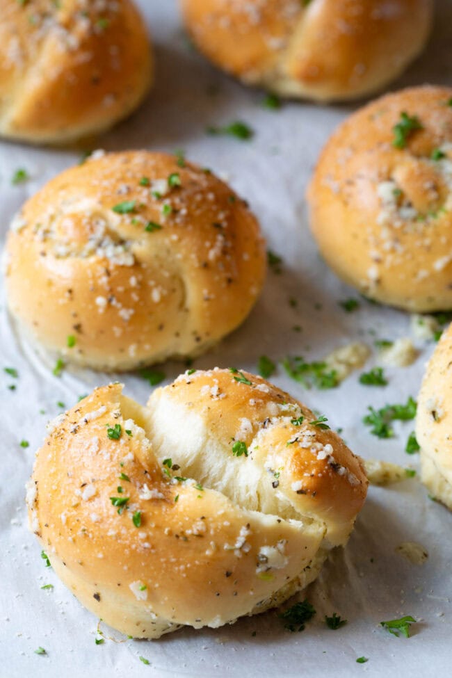 Garlic knot ripped in half to show the texture of the inside.