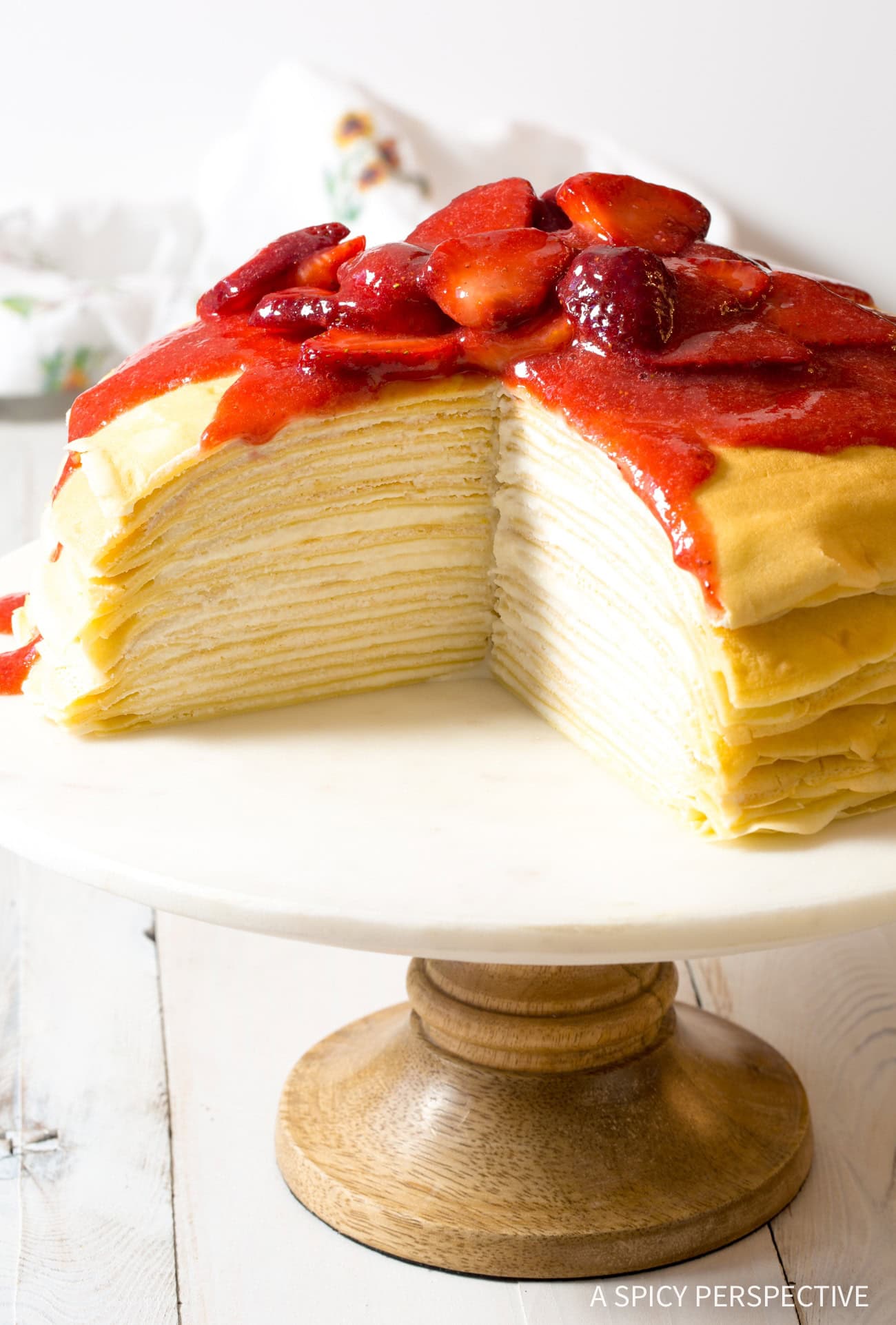 Lemon-Ricotta-Crepe-Cake-1 complete lemon ricotta crepe cake on a cake stand